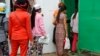 Cambodian garment workers return to a factory after their lunch break in Phnom Penh, Cambodia Thursday, March 12, 2015. 