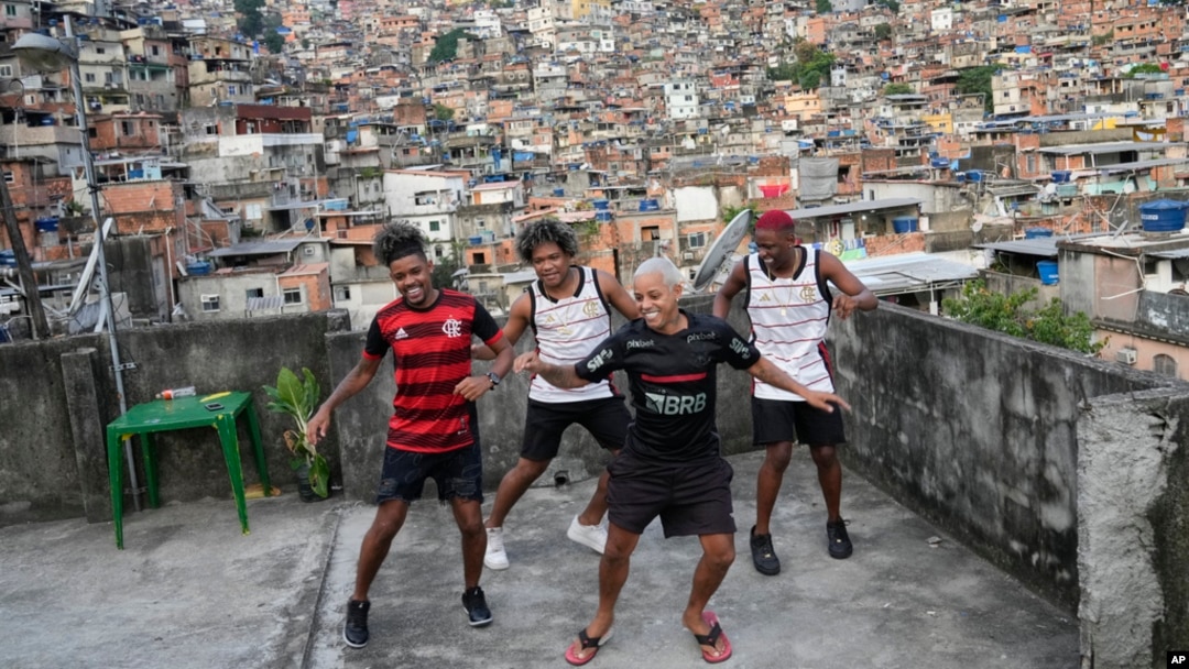 FILE - Youths perform a street dance style known as passinho for their social media accounts, in the Rocinha favela of Rio de Janeiro, April 17, 2024. 