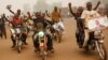 Supporters of presidential candidate Faustin Archange Touadera rally during a sandstorm in the streets of Bangui, Central African Republic, Feb. 12, 2016.