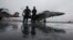 U.S. Navy deck crew members stand in front of an F/A-18 fighter jet on the aircraft carrier USS George Washington in Hong Kong November 9, 2011. 