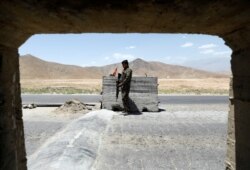 An Afghan National Army soldier stands guard at a checkpoint near Bagram Airfield, on the day the last of the American troops vacated it, Parwan province, Afghanistan, July 2, 2021.