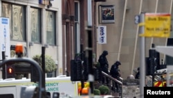 Special police forces walk at the scene of reported multiple stabbings at West George Street in Glasgow, Scotland, Britain, June 26, 2020. 