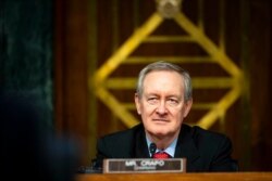 FILE - Chairman Mike Crapo, R-Idaho, listens during a Senate Banking Committee hearing on Capitol Hill, Dec. 1, 2020.