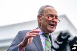 FILE - Senate Majority Leader Chuck Schumer of N.Y., speaks to members of the media outside the West Wing following an event about government regulations on AI systems at the White House in Washington, Oct. 30, 2023.