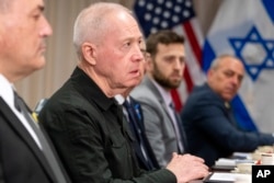 FILE— Israeli Defense Minister Yoav Gallant, second from left, meets with Defense Secretary Lloyd Austin at the Pentagon, March 26, 2024, in Washington.