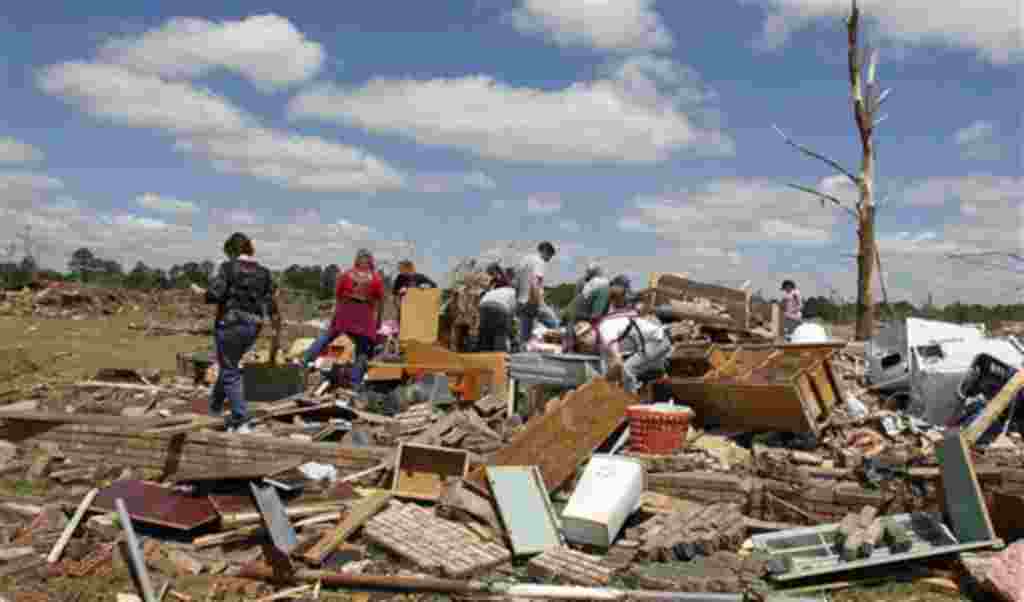 Residents search through what is left of their homes after a tornado hit Pleasant Grove just west of downtown Birmingham yesterday afternoon on Thursday, April 28, 2011, in Birmingham, Ala. President Barack Obama said he would visit Alabama Friday to vie