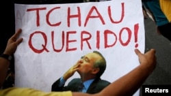 A man holds a sign that reads "Bye Darling" in reference to Brazil's Senate President Renan Calheiros, as he takes part in a protest against corruption in Sao Paulo, Brazil, Dec. 4, 2016. Calheiros was removed from office on Monday, Dec. 5, 2016. 