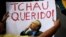 A man holds a sign that reads "Bye Darling" in reference to Brazil's Senate President Renan Calheiros, as he takes part in a protest against corruption in Sao Paulo, Brazil, Dec. 4, 2016. Calheiros was removed from office on Monday, Dec. 5, 2016. 