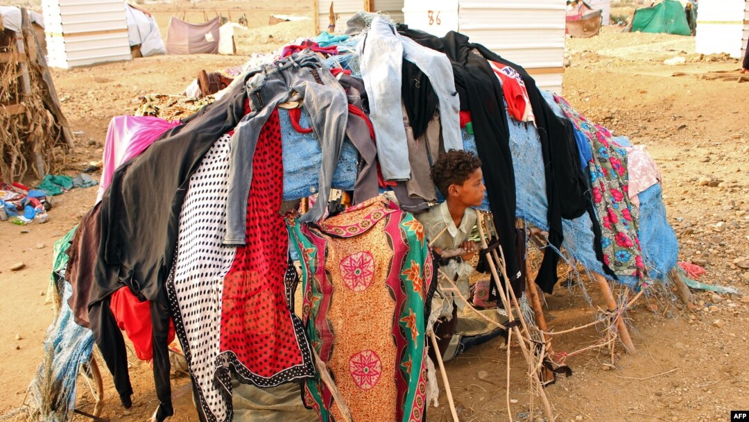 FILE - A displaced child who fled the fighting sits at a makeshift camp in the district of Abs, in Yemen's northwestern Hajjah province, June 10, 2019.