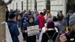 FILE—A demonstrator holds a poster saying, "Hands off Memorial, freedom for political prisoners" as people gather in front of the Russian Supreme Court in Moscow, Russia, on December 14, 2021.