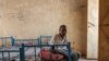 FILE - Kheder Adam, an Eritrean refugee who fled Ethiopia's Tigray conflict, rests on his bed at the Border Reception Centre in Hamdayit, eastern Sudan, Dec. 8, 2020. 