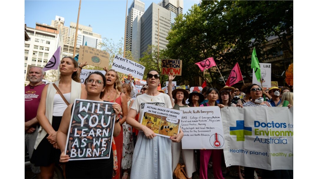 Protesters hold placards during a climate change rally in Sydney, Jan. 10, 2020.
