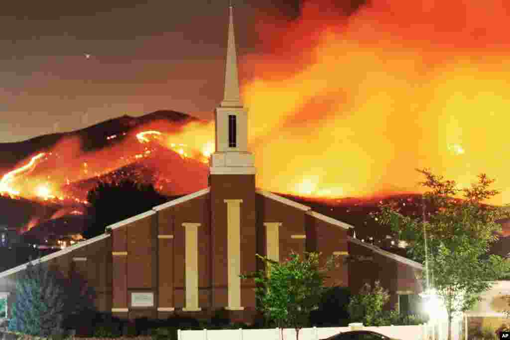 The Traverse Fire burns near homes in Lehi, Utah. Officials say fireworks caused the wildfire and forced evacuations early Sunday morning. (Photo taken by Justin Reeves)