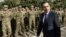 Georgian Defense Minister Irakli Alasania passes soldiers while visiting the Mukrovani military base, east of Tbilisi, Georgia, Nov. 7, 2012. 