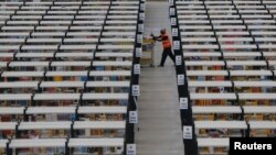 Un empleado de Amazon recoge órdenes en un centro de acopio de la empresa Amazon, en Rugeley, Inglaterra.