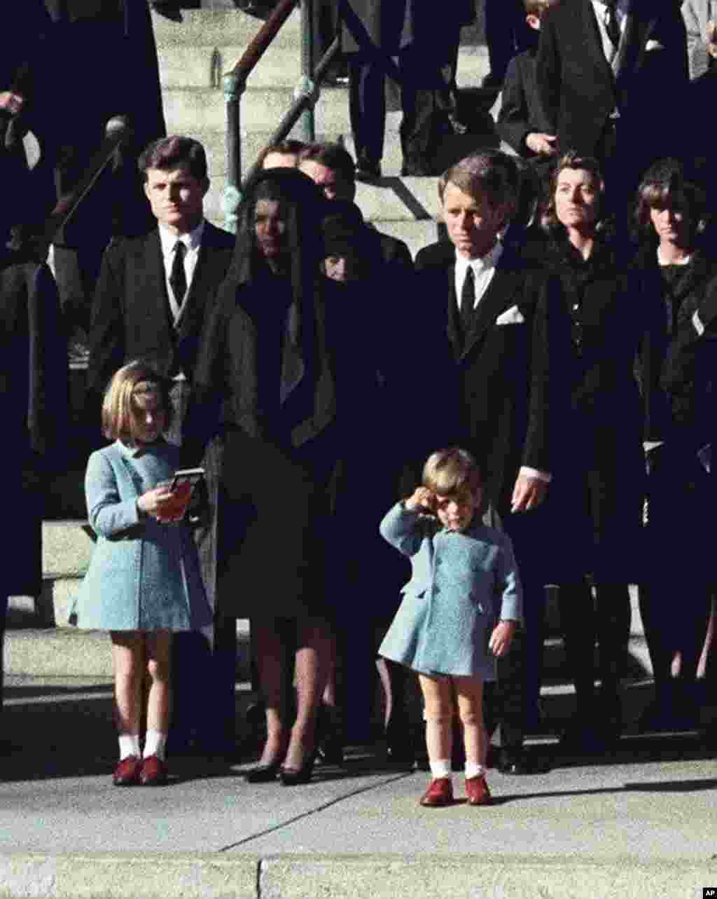 John F. Kennedy Jr. yang berusia tiga tahun memberi hormat di depan jenazah ayahnya di Washington, 25 November 1963.