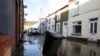 A view shows a partially submerged rubbish bin on a mud-covered street, in the aftermath of Storm Bert, in Cwmtillery, South Wales, Britain, Nov. 25, 2024. 