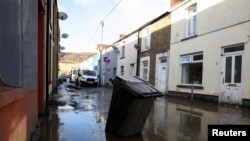 A view shows a partially submerged rubbish bin on a mud-covered street, in the aftermath of Storm Bert, in Cwmtillery, South Wales, Britain, Nov. 25, 2024. 