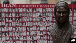 Bust of Iranian Protest Victim Neda Agha Soltan, a student killed during election protests in Tehran in 2009, is seen in front of a banner showing pictures of what Iranian opposition groups say are victims of the Iranian regime.