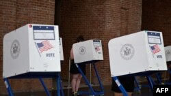 FILE - Residents vote during the New York City mayoral primary election at the Brooklyn Museum polling station, in New York City, June 22, 2021. A tabulation error has cast a shadow on the final vote count.