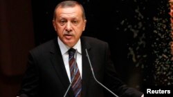 Turkey's Prime Minister Tayyip Erdogan addresses members of his ruling AK Party during a meeting at the party headquarters in Ankara, Turkey, Aug. 14, 2014.