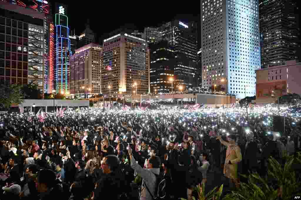 People take part in a gathering of thanks at Edinburgh Place in Hong Kong's Central district after U.S. President Donald Trump signed legislation requiring an annual review of freedoms in Hong Kong.