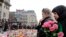 People observe a minute of silence at a street memorial to victims of Tuesdays's bombings in Brussels, Belgium, March 24, 2016. 
