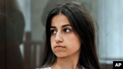 FILE - Angelina Khachaturyan attends a court hearing in Moscow, Russia, June 26, 2019. She and her two sisters are accused of murdering their father who, investigators confirmed, abused them for years.