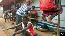 Victims of mutilations perpetrated by rebels of the Revolutionary United Front (RUF) gather at the Handicap International camp in Freetown, May 18, 2000. (AFP) 