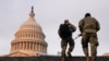 National Guard members walk at the Capitol,