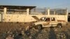 FILE - A car sits next to a salvage yard hit by a Houthi rocket in an industrial area in eastern Najran city, Saudi Arabia, Aug. 27, 2016. 