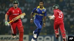 FILE: Sri Lankan bowler Nuwan Kulasekara, center, runs along with Zimbabwe's batsmen Brendan Taylor, left, and Regis Chakabva during the Cricket World Cup match between Sri Lanka and Zimbabwe in Pallekele, Sri Lanka, Thursday, March 10, 2011. (AP Photo/Eranga J