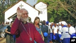 The Archbishop of Canterbury, Rowan Williams (L), waves as he arrives at the Anglican church in the Thyolo district east of Blantyre, Malawi, October 7, 2011.