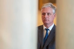 FILE - National security adviser Robert O'Brien listens as President Donald Trump addresses the nation from the White House on the ballistic missile strike that Iran launched against Iraqi air bases housing U.S. troops in Washington, Jan. 8, 2020.