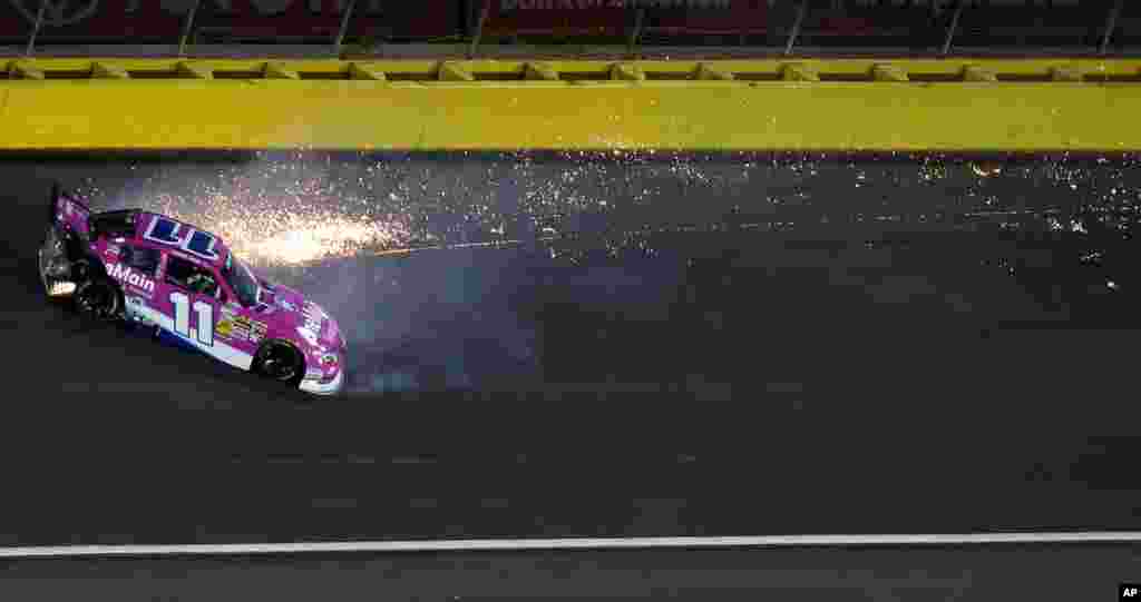 Elliott Sadler (11) spins between Turns 3 and 4 during the NASCAR Nationwide Series auto race at Charlotte Motor Speedway in Concord, North Carolina, USA, Oct. 11, 2013. 