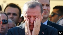 Turkish President Recep Tayyip Erdogan wipes tears during the funeral of Mustafa Cambaz, Erol and Abdullah Olcak, killed Friday while protesting the attempted coup against Turkey's government, in Istanbul, July 17, 2016. 