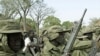 Child soldiers of the rebel Sudan People's Liberation Army (SPLA) wait for their commander at a demobilization ceremony at their barracks in Malou, southern Sudan Sunday, February 25, 2001 (file photo).