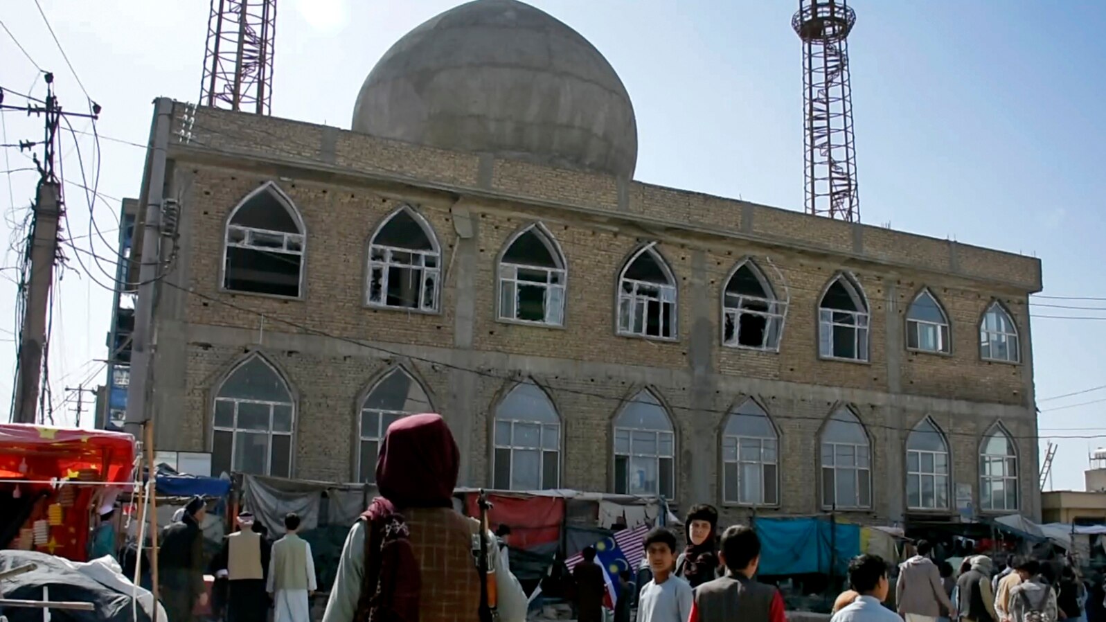 FILE - This frame grab image from video, shows a Taliban fighter standing guard outside the site of a bomb explosion inside a mosque, in Mazar-e-Sharif province, Afghanistan, April 21, 2022.