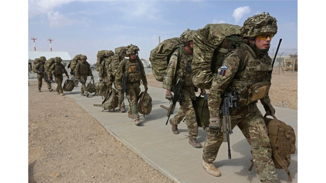 FILE - British troops prepare to depart upon the end of operations for U.S. Marines and British combat troops in Helmand, Afghanistan, Oct. 27, 2014.