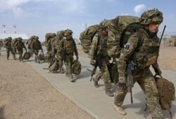 FILE - British troops prepare to depart upon the end of operations for U.S. Marines and British combat troops in Helmand, Afghanistan, Oct. 27, 2014.