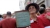 FILE - A woman holds a copy of the U.S. Constitution during a rally in New Orleans after two Supreme Court decisions supporting gay rights were handed down, June 26, 2013.