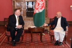 U.S. Secretary of State Mike Pompeo, left, meets with Afghan President Ashraf Ghani, at the Presidential Palace in Kabul, Afghanistan, March 23, 2020.
