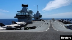 FILE - F-35B Lightning II aircrafts are seen on the deck of the HMS Queen Elizabeth aircraft carrier offshore Portugal, May 27, 2021.