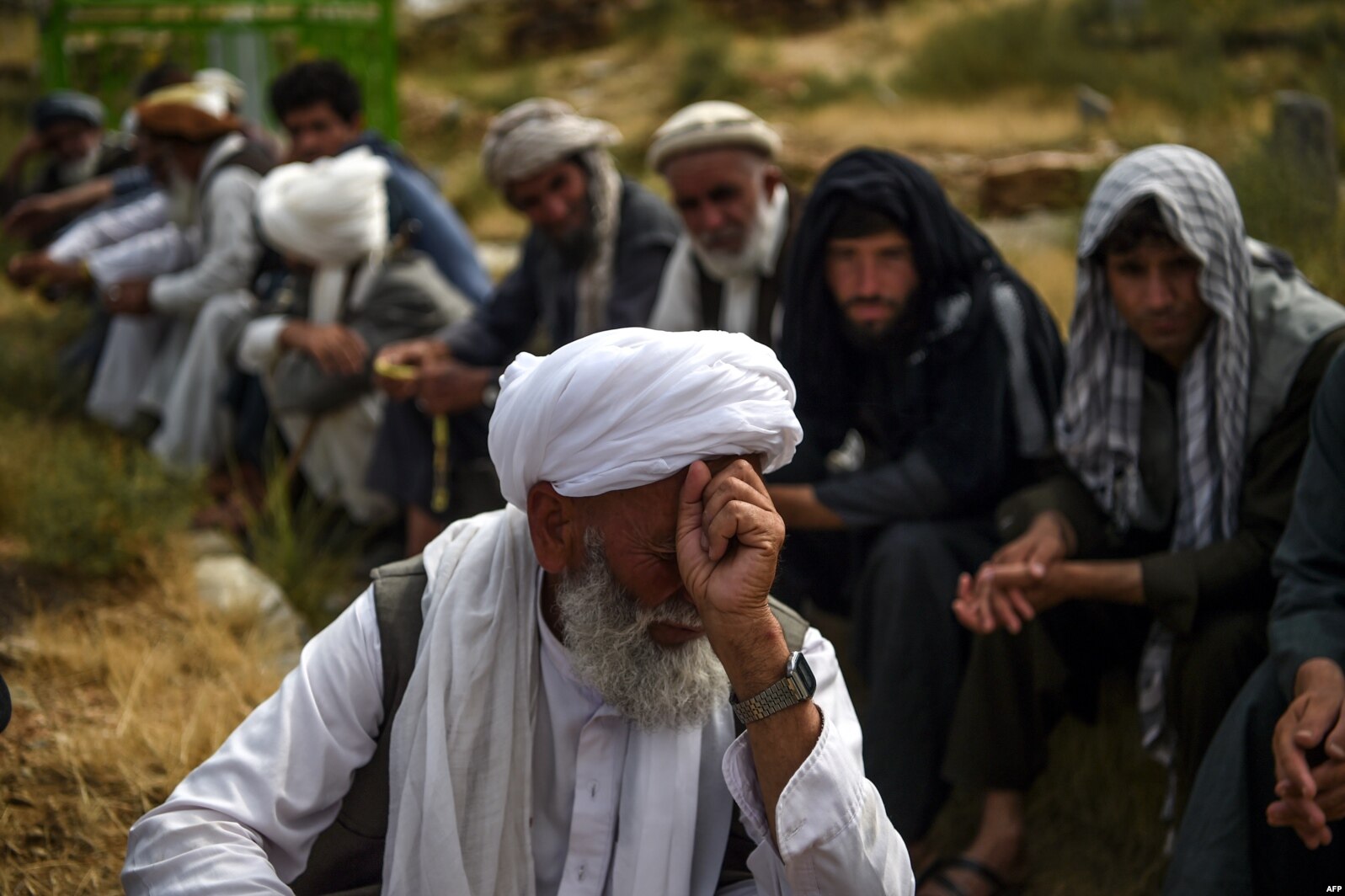A mourner reacts as he attends a burial ceremony of the victims who died in the flash flood that affected the area, at a cemetery near Sayrah-e-Hopiyan in Charikar, Parwan province, Afghanistan.