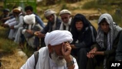 A mourner reacts as he attends a burial ceremony of the victims who died in flooding that affected the area, at a cemetery near Sayrah-e-Hopiyan in Charikar, Parwan province, Afghanistan.