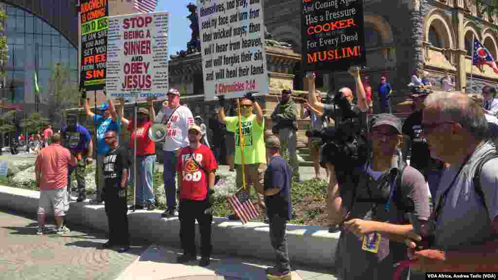 Protesters with religious signs at Westboro Baptist rally.