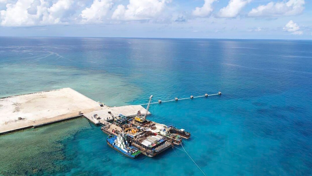 In this photo provided by the Department of National Defense, ships carrying construction materials are docked at the new beach ramp at the Philippine-claimed island of Pag-asa in the South China Sea on June 9, 2020.