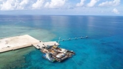 In this photo provided by the Department of National Defense, ships carrying construction materials are docked at the new beach ramp at the Philippine-claimed island of Pag-asa in the South China Sea on June 9, 2020.