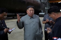 North Korean leader Kim Jong Un visits a submarine factory in an undisclosed location in North Korea, July 22, 2019.