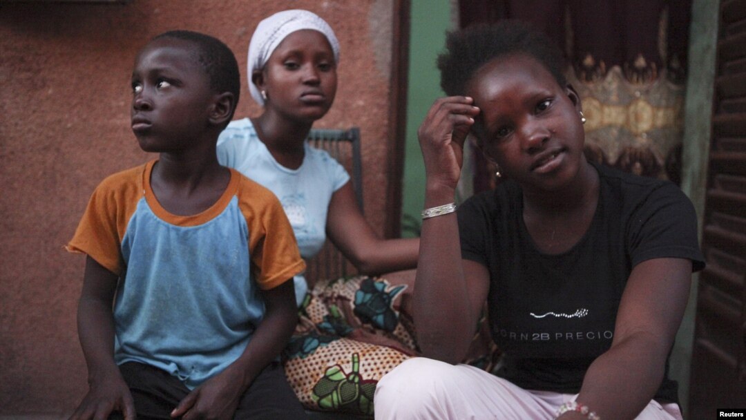 Refugees from the Malian town of Gao, which is now under the control of Islamist forces, pose at a private accommodation in the capital Bamako, September 8, 2012. 